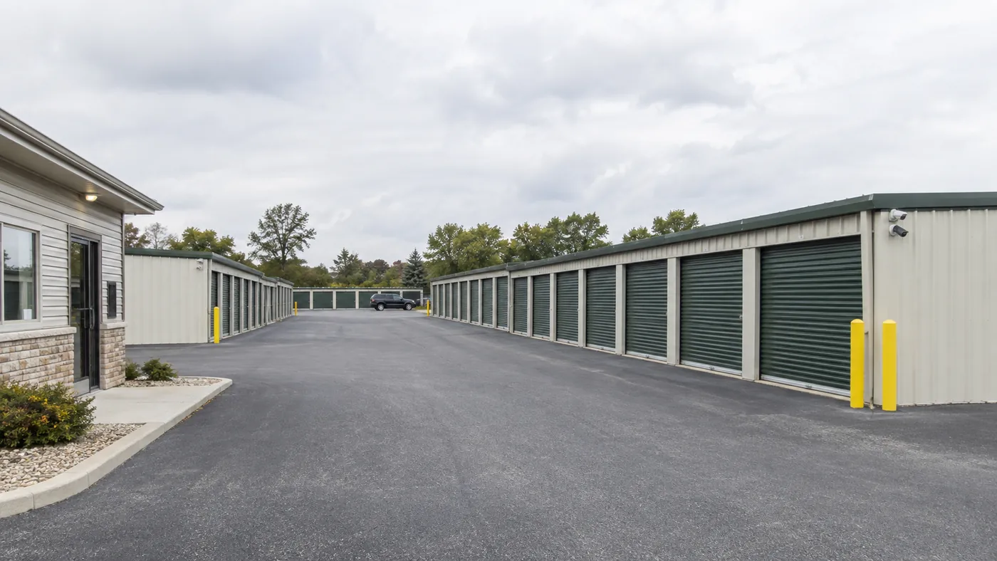 Illustrative scene of a drive aisle between self-storage units and an office